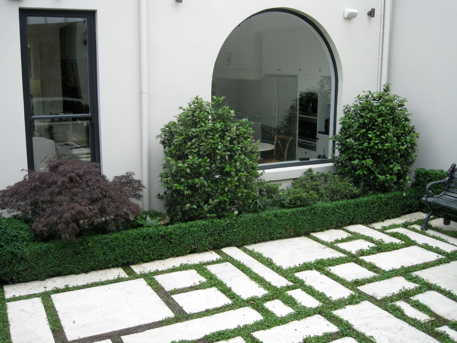 Curved lawn bordered by deep mixed planting