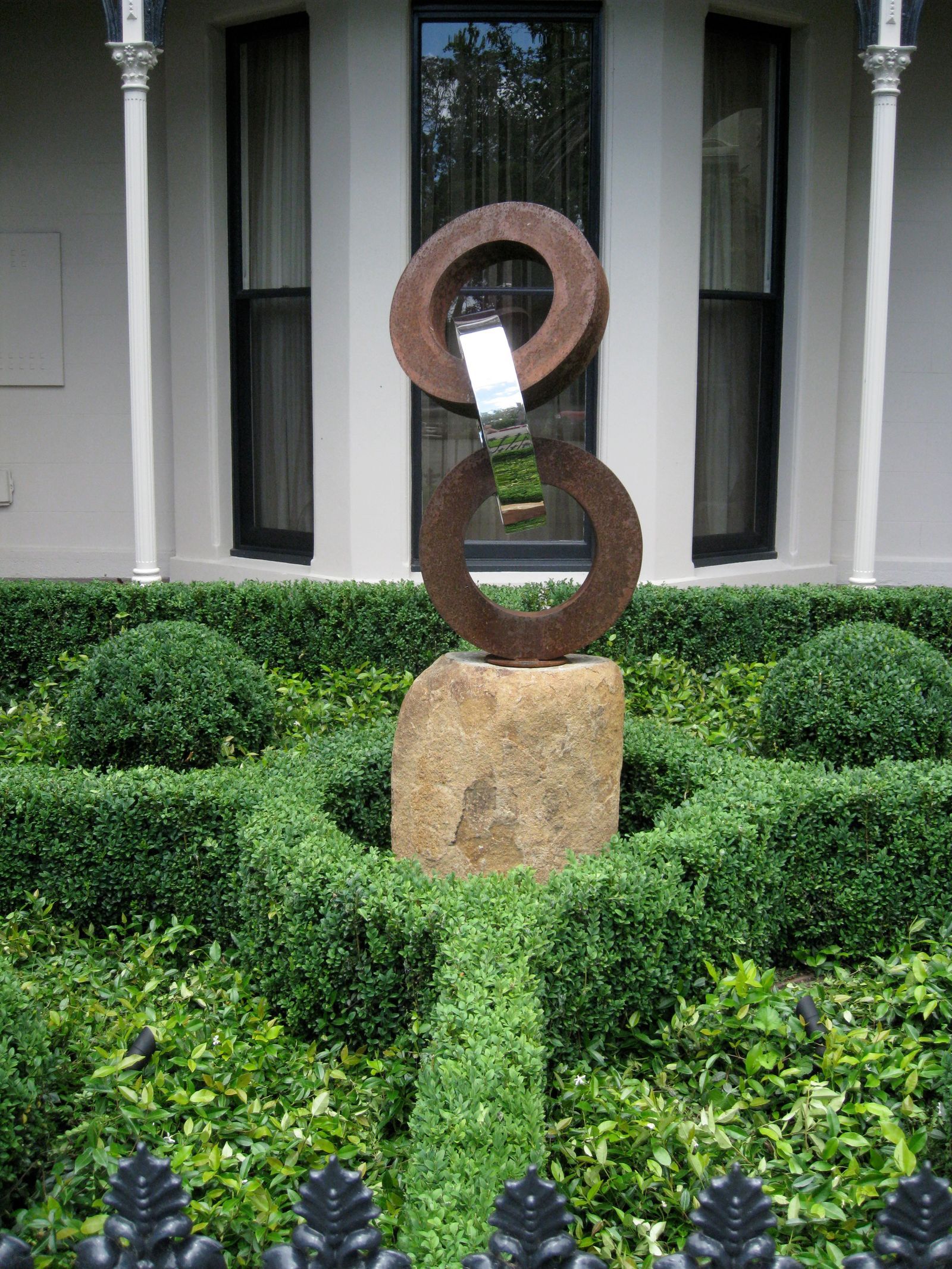 Sandstone wall with spheres of clipped box