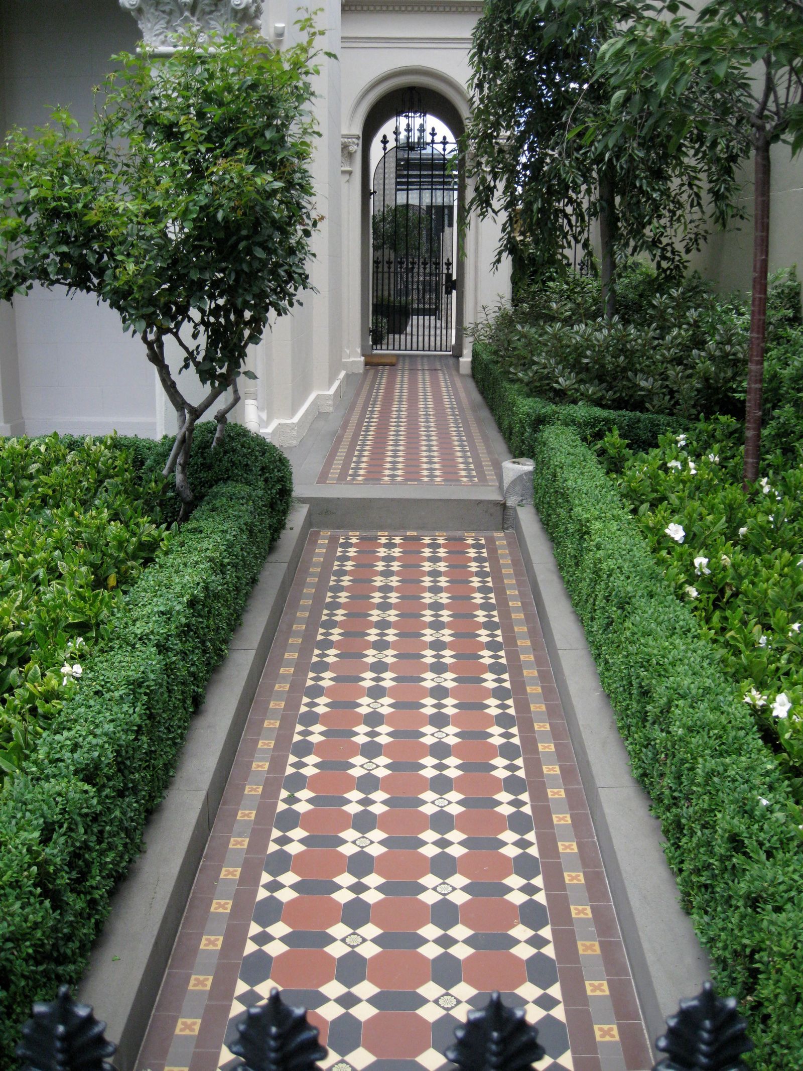 Brick path through a lush garden in Middle Park